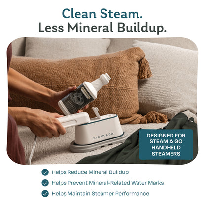 Filling a Steam & Go handheld garment steamer with demineralized water to reduce mineral buildup and prevent water marks